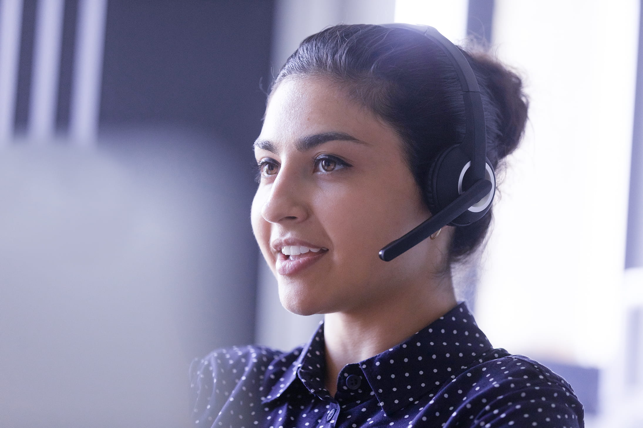 Customer service representative assisting someone on the phone.